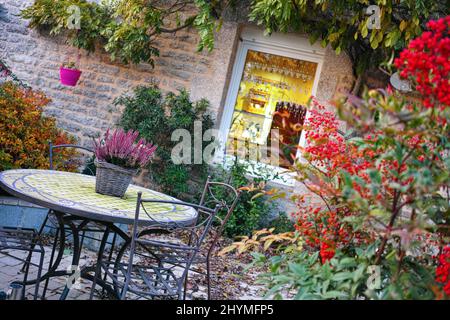 Country Cottage in France, cozy set of table and chairs in the garden, Bretagne, France. Stock Photo