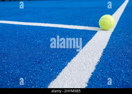 Bright blue tennis, paddle ball or pickleball court close up of service line. selective focus