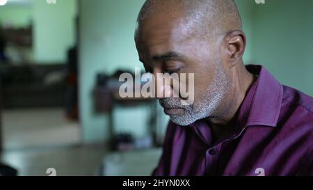 A struggling pensive senior African man feeling anxious Stock Photo