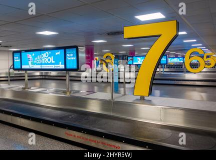 Colourful and modern airport baggage carousel showing no people or luggage Stock Photo