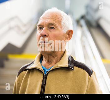 Portrait of old man going to metro station Stock Photo