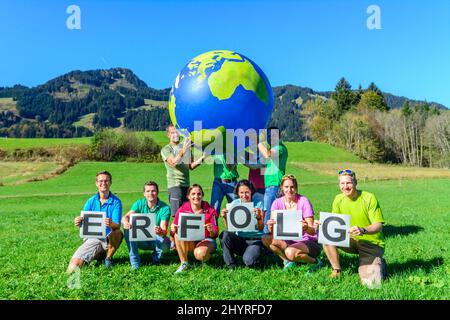 Successful only together - let us carry the world on our hands Stock Photo