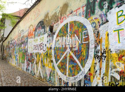 The Lennon Wall in Prague, Czech Republic, which was formerly an ordinary historic wall, but since the 1980s, people have filled it with John Lennon-inspired graffiti and pieces of lyrics from Beatles songs. Stock Photo