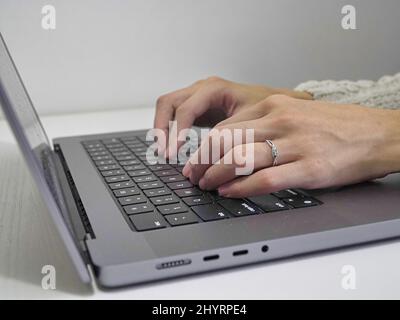Woman hands typing on laptop Stock Photo