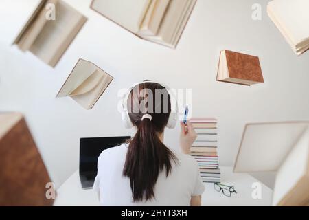 Portrait of a female student with books and glasses. Young female student reading books and preparing for exams. Creative photo Stock Photo