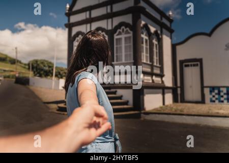 Shallow focus shot of a female in front of the Empire of Espirito Santo de Porto Martins Stock Photo