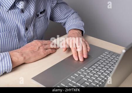 Man hand closeup on laptop touchpad. Using computer for entertainment, freelance work and distant education. High quality photo Stock Photo