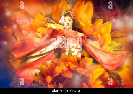 Japanese geisha with fan dancing with sunflowers background. Stock Photo