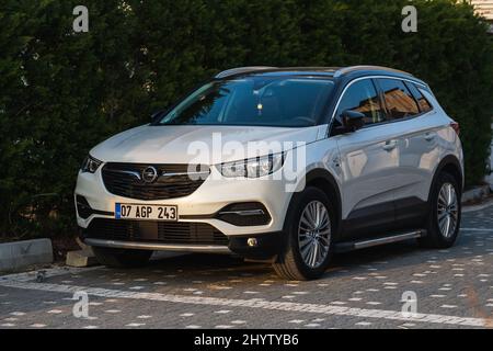 Side, Turkey -February  18, 2022:   white Opel Grandland X  is parking  on the street on a  summer day Stock Photo