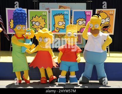 Characters dressed as The Simpsons, from left, Marge, holding Maggie, Lisa, Bart and Homer pose at 'The Simpsons' Stamp Dedication Ceremony held at Fox Studio, Los Angeles Stock Photo