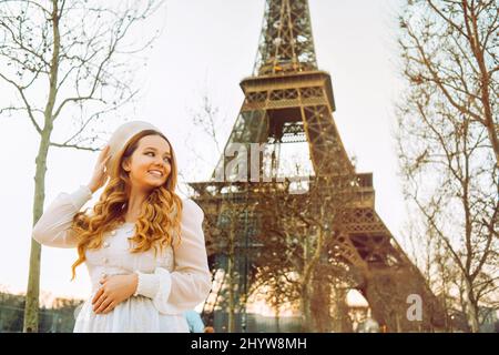 A girl against the backdrop of the Eiffel Tower in Paris in a