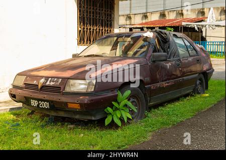 Abandoned Proton Car at Kampung Baru, Kuala Lumpur Stock Photo