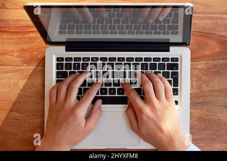 Hes a hands-on business man. Cropped shot of a businessmans hands on a laptop keyboard. Stock Photo