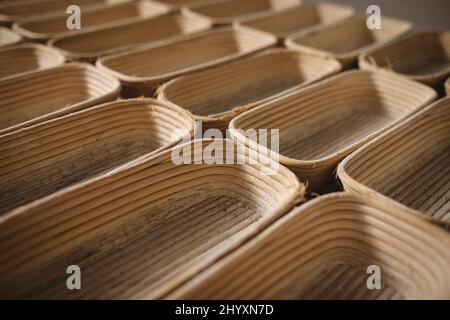 Full frame shot of wicker bread baskets arranged side by side in bakery Stock Photo
