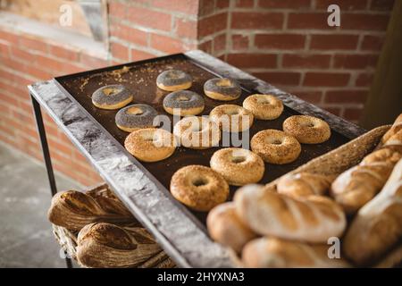 High angle view of donuts and breads arranged on table in bakery Stock Photo