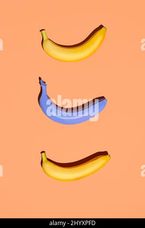 Minimal flat lay of three bananas on pastel colored background, vegan diet concept, copy space Stock Photo