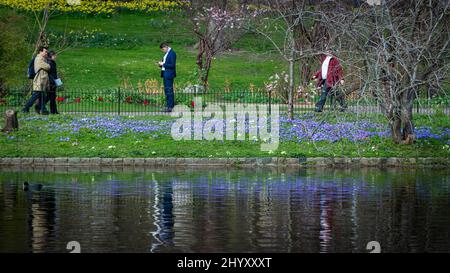 London, UK.  15 March 2022.  UK Weather – People reflected in the lake in St James’s Park on a warm afternoon .  A period of further warm weather is forecast until the end of the week. Credit: Stephen Chung / Alamy Live News Stock Photo