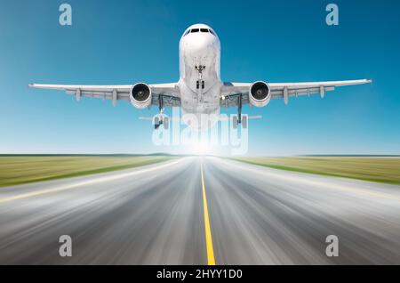 Airplane flying departure landing speed motion on a runway in the clear sky bright day Stock Photo
