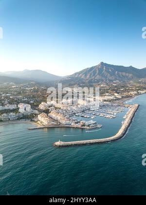 Aerial drone perspective of beautiful sunset over luxury Puerto Banus Bay in Marbella, Costa del Sol. Expensive lifestyle, luxury yachts. Stock Photo