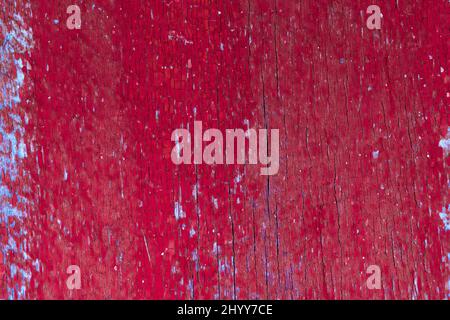 Red wood background. Old weathered wooden plank painted in red. Vintage texture closeup Stock Photo
