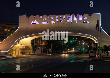 Entrance in Marbella city, famous and emblematic sign, arch , night perspective - illuminated in different colours. Night photography Stock Photo