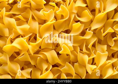 Pile of Egg Noodle Pasta Background Close Up. Stock Photo