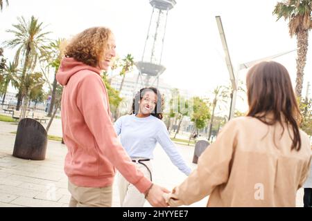 Multiracial community holding hands in lovely unity and peace Stock Photo
