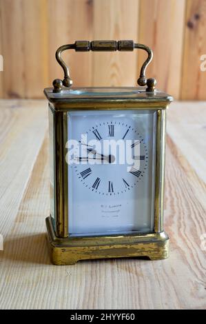 Old carriage clock on a table Stock Photo
