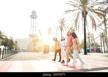 Group Of Friends Crossing Urban Street In New Barcelona Stock Photo