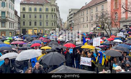 War in Ukraine. Ukrainian demonstrators with banners and Ukrainian flags protested against Russia's interference in Ukraine. Peaceful protest of Stock Photo