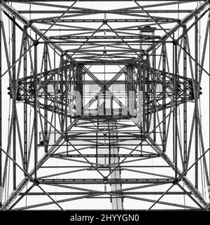 Monochrome image of an electrical tower looking upwards  giving a geometric abstract appearance which resembles a test pattern Stock Photo