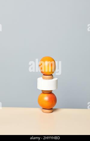 Minimal image of tropical grapefruits stacked against pastel background, 3D shape and dimension, dieting Stock Photo