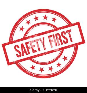 SAFETY FIRST text written on red round vintage rubber stamp. Stock Photo