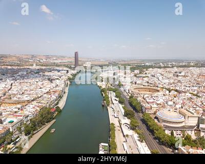 Aerial perspective of Seville city. View of the  Guadalquivir River, the western part of the city. Promenade area with bars and terraces. Stock Photo