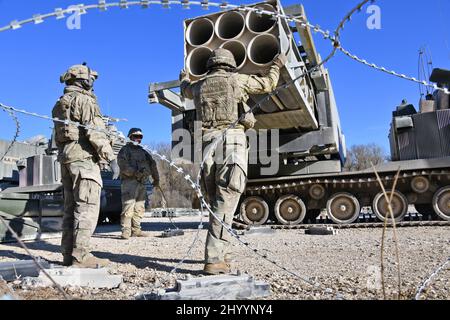 Grafenwoehr, Bayern, Germany. 11th Mar, 2022. U.S. Soldiers assigned to 41st Field Artillery Brigade load M270 Multiple Launch Rocket Systems for a live fire exercise at the 7th Army Training Command's Grafenwoehr Training Area, Germany, March 11, 2022. The deployment of U.S. forces here is a prudent measure that underpins NATO's collective war-prevention aims, defensive orientation and commitment to protect all Allies. Credit: U.S. Army/ZUMA Press Wire Service/ZUMAPRESS.com/Alamy Live News Stock Photo