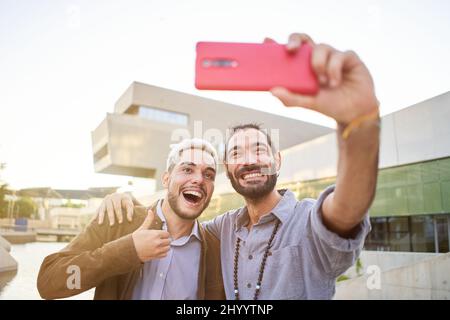 Happy gay couple taking smiling selfie. Homosexual people having fun Stock Photo