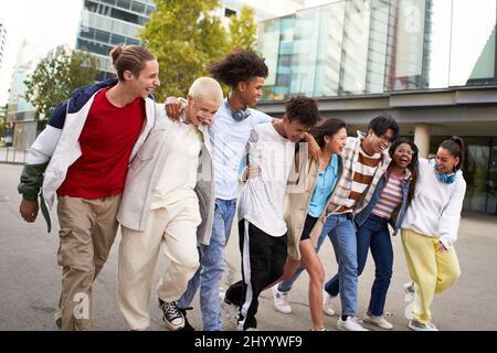 Multiracial friends group portrait outside. Happy multi cultural people smiling outdoors. College students, friendship and community concept Stock Photo