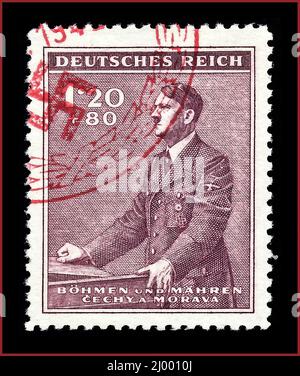 POSTAGE STAMP ADOLF HITLER Semi-postal surcharge stamp of the Nazi-German 'Protektorat Böhmen und Mähren' (Protectorate of Bohemia and Moravia); 1942; semi-postal stamp of the issue to the '53th anniversary of birth of the 'Führer'' Adolf Hitler; stamp motive shows Hitler at a lactern; The Nazi-protectorate 'Bohemia and Moravia' existed 1939-1945 from 15 March 1939 until to 8 May 1945 as part of homeland of the German Empire. Stock Photo