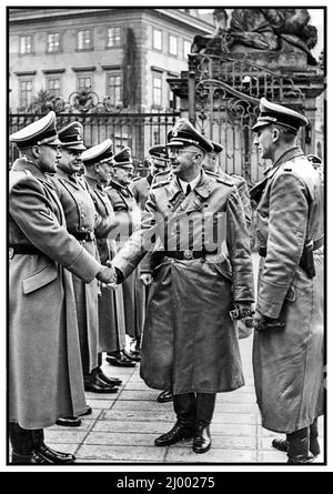Reinhard Heydrich 1941 – the commander of the Reich Security Main Office (RSHA), acting governor of the Protectorate of Bohemia and Moravia, and a principal architect of the Holocaust with Heinrich Luitpold Himmler Reichsführer of the Schutzstaffel, and leading member of the Nazi Party of Germany. Pictured in Prague Czechoslovakia meeting Nazi officers under Heydrich's command Stock Photo