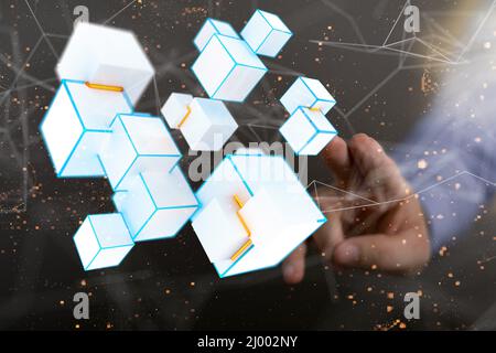 Businessman tapping on a digital network of connected white cubes Stock Photo