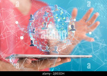 A businessman holding a tablet with a floating digital render of a global profile network Stock Photo