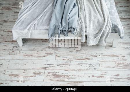 Gray warm blankets for the interior in the apartment lie on the bed Stock Photo