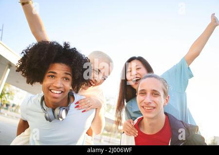 Happy group of young people having fun together outdoors. Stock Photo