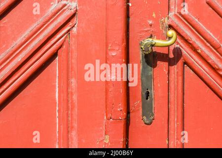 Old copper door handle on red wooden door, Sopron, Hungary Stock Photo