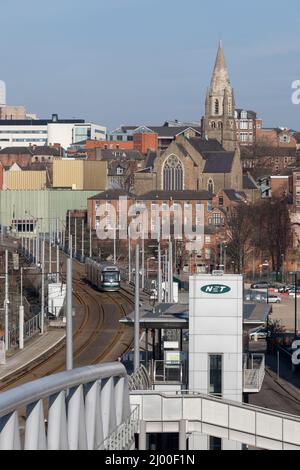 Nottingham Express transit Bombardier Incentro tram 208  Dinah Minton arriving at Nottingham railway station with the city behind Stock Photo