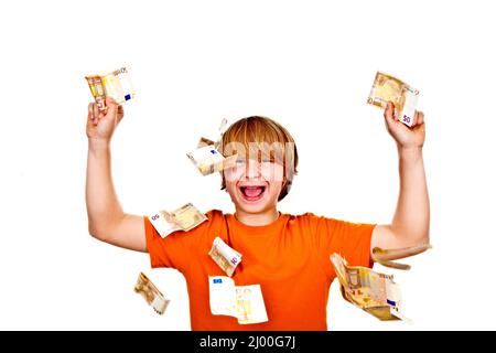 Euros flying around a boys head Stock Photo