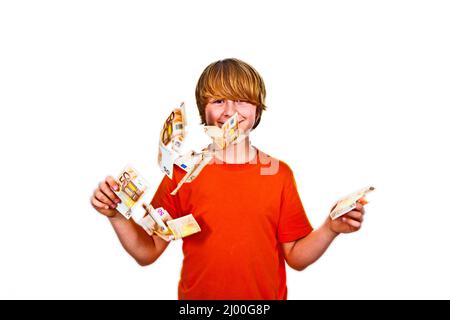 Euros flying around a boys head Stock Photo