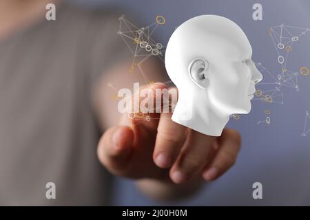 Close-up shot of a hand touching white human head with network plexus structure Stock Photo