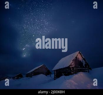 View at the starry sky and old house on mountain slope. Dramatic and picturesque scene. Location place Carpathian, Ukraine, Europe. Discover the world Stock Photo