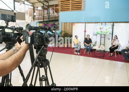 Television studio with professional cameras broadcasting a live show on a set Stock Photo